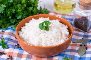 White rice in bowl. Rice on wooden table